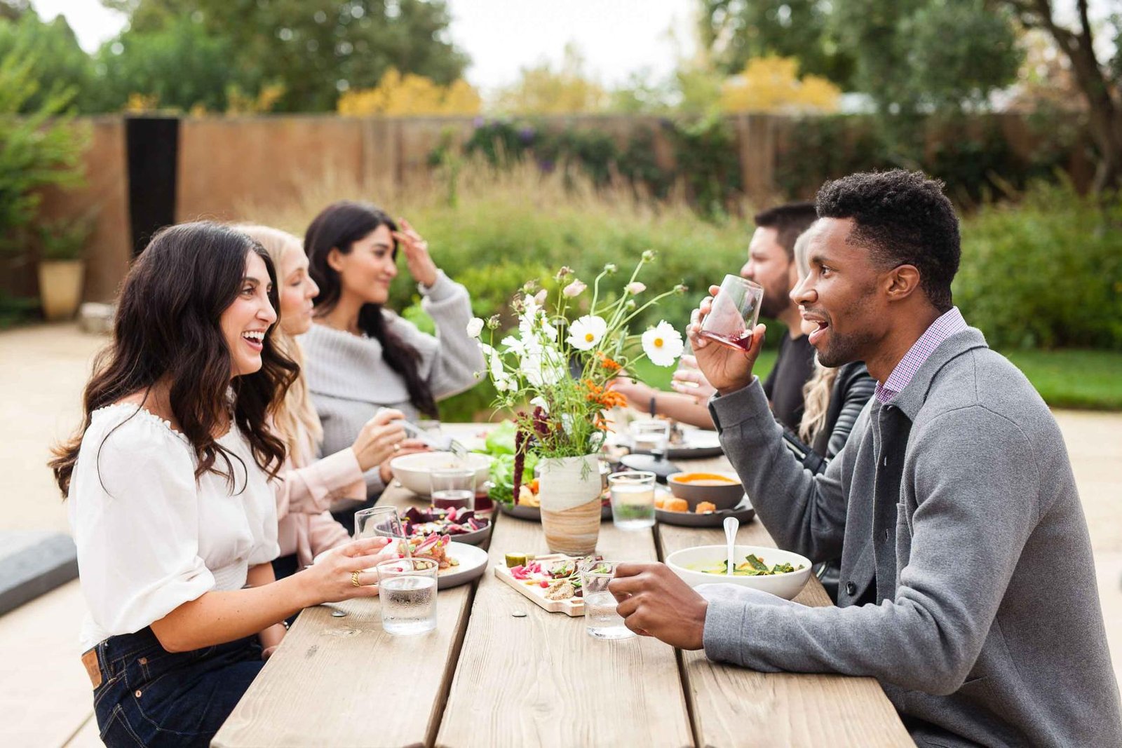 people sitting on a table having a great time with an amazing meal